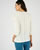 Opengewerkte en geborduurde top van stretch jacquardtricot